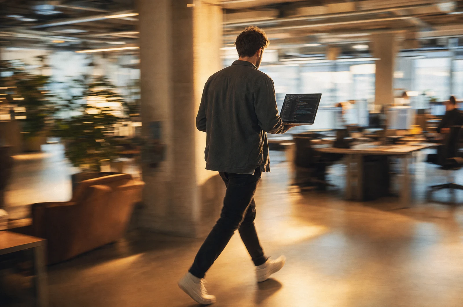 A developer writing code on their screen in a quiet office in the evening